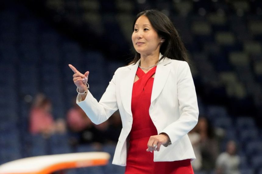 USA Gymnastics president Li Li Leung walks on stage after the senior men's finals of the U.S. Gymnastics Championships in New Orleans, Saturday, Aug. 9, 2025. (AP Photo/Gerald Herbert)