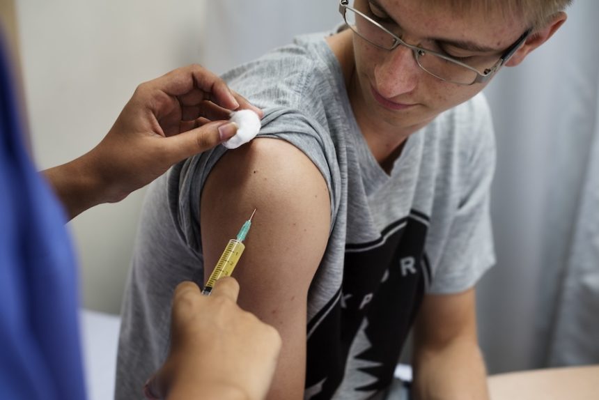 young man having a vaccination 2025 02 10 11 10 52 utc