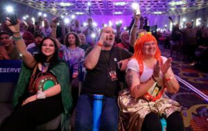 Rachel Cox, Mark Woodring, Shannon Woodring, and other members of the audience applaud and hold up phone flashlights after a "Lord of the Rings"; panel at FanX at the Salt Palace Convention Center in Salt Lake City on Thursday. | Kristin Murphy, Deseret News
