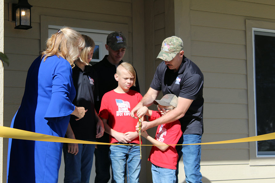 The Byers family cutting the ribbon to enter their new home. | Kaitlyn Hart, EastIdahoNews.com