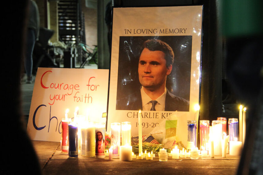 Candles set by a photo of Charlie Kirk following the service.