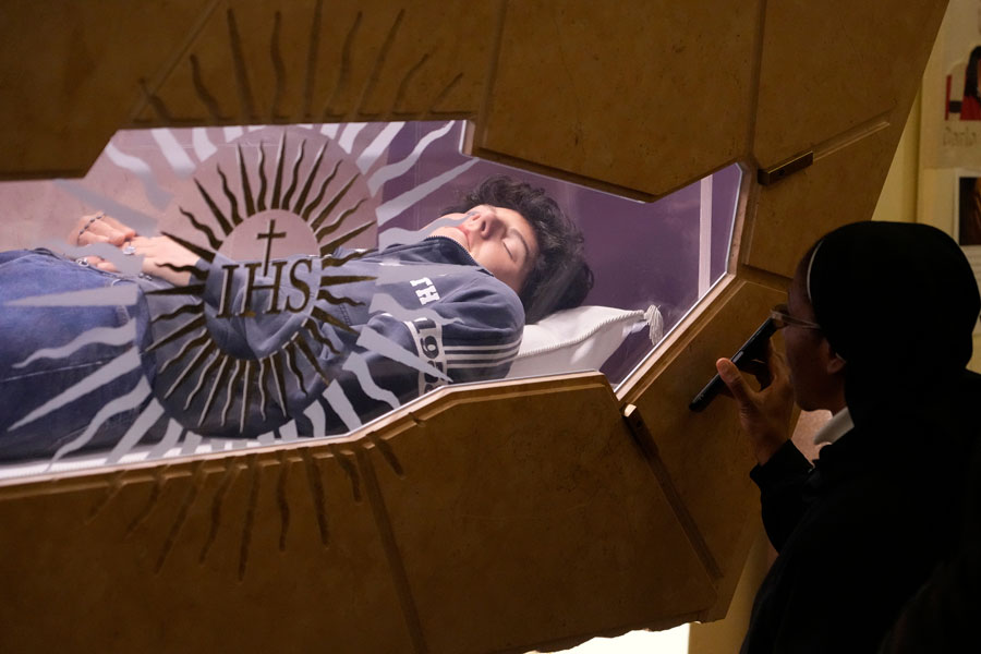 The body of Carlo Acutis, an Italian boy who died in 2006 of leukemia, lies in his tomb in Assisi, Italy, March 1, 2025. (AP Photo/Gregorio Borgia, File)