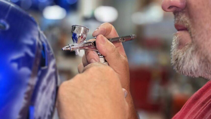 Armando Villareal hand paints Boise State helmets. | Idaho Statesman.