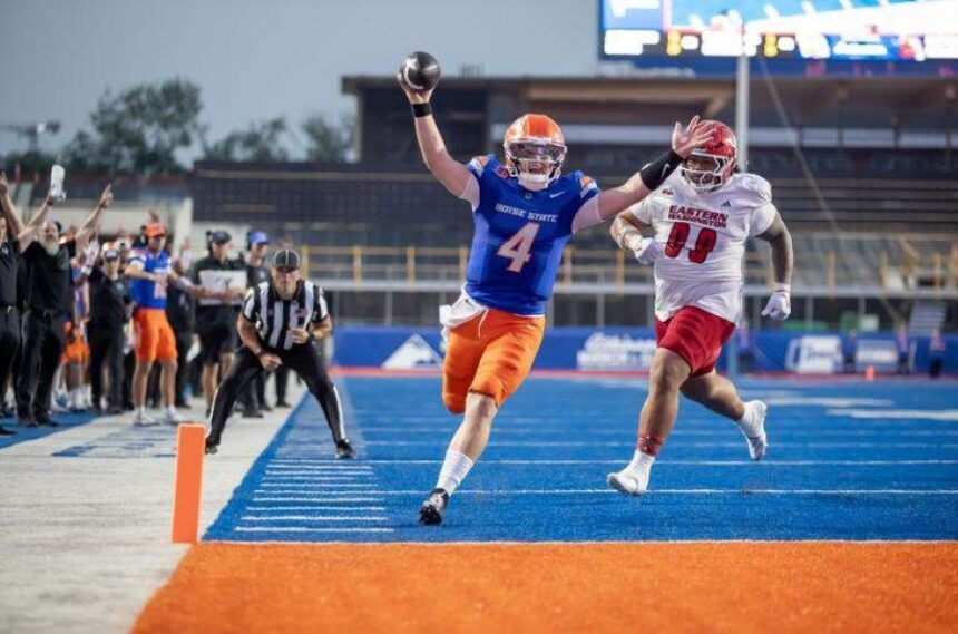 Boise State quarterback Maddux Madsen scores a second quarter touchdown while being pursued by Eastern Washington defensive lineman Jheison Saunds. Boise State leads Eastern Washington 30-7 at the half in the Broncos’ home opener at Albertsons Stadium, Sept. 5, 2025. Kyle GreenFor The Idaho Statesman