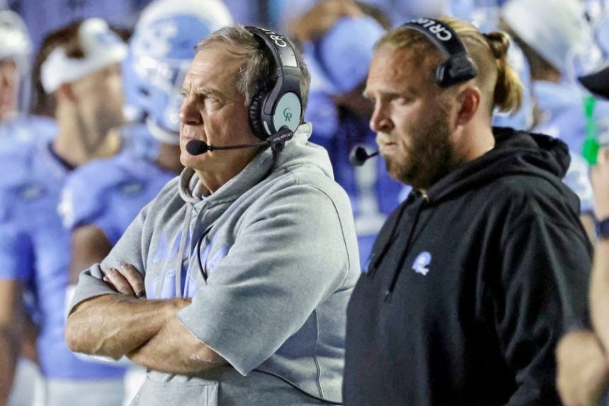 North Carolina head coach Bill Belichick, left, and his son, Steve Belicheck, right, the defensive coordinator, watch in the closing minutes of the second half of an NCAA college football game against TCU, Monday, Sept. 1, 2025, in Chapel Hill, N.C. (AP Photo/Chris Seward)