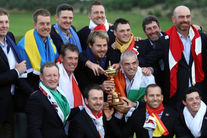 FILE - Europe team captain Paul McGinley, center right, and his team wear their national flags and celebrate with the trophy after winning the Ryder Cup golf tournament at Gleneagles, Scotland, Sunday, Sept. 28, 2014. (AP Photo/AP Photo/Peter Morrison, File)