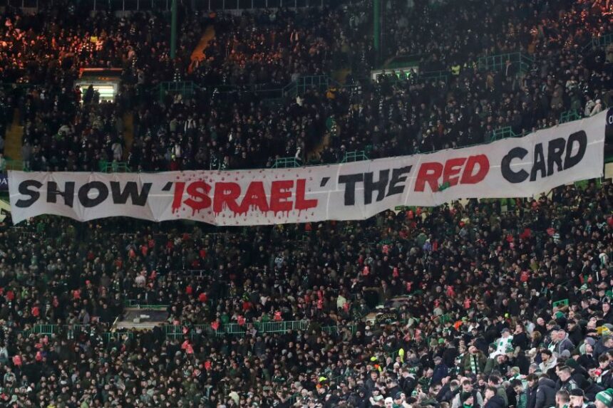 FILE - Celtic fans lift a protest banner about Israel during the Champions League playoff first leg soccer match between Glasgow Celtic and Bayern Munich at the Celtic Park Stadium in Glasgow, Scotland, Wednesday, Feb. 12, 2025. (AP Photo/Scott Heppell, File)