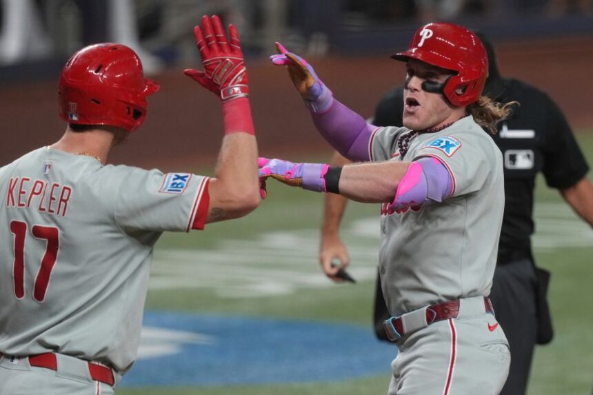 Philadelphia Phillies' Harrison Bader, right, celebrates with Max Kepler (17) after hitting a home run during the fourth inning of a baseball game against the Miami Marlins Friday, Sept. 5, 2025, in Miami. (AP Photo/Marta Lavandier)