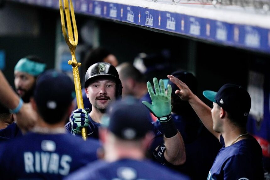 Seattle Mariners' Cal Raleigh carries a trident after hitting a solo home run, his 57th of the season, against the Houston Astros during the third inning of a baseball game Saturday, Sept. 20, 2025, in Houston. (AP Photo/Eric Christian Smith)