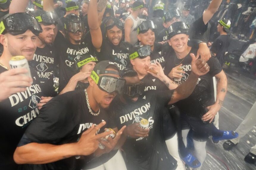 The Seattle Mariners celebrate after the team's win against the Colorado Rockies to clinch the American League West Division, Wednesday, Sept. 24, 2025, in Seattle. (AP Photo/Ryan Sun)