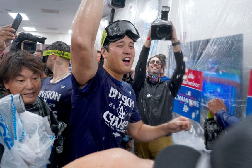 Los Angeles Dodgers two-way player Shohei Ohtani (17) center, celebrates after the Dodgers clinched the National League West title against the Arizona Diamondbacks during a baseball game at Chase Field Thursday, Sept. 25, 2025, in Phoenix. (AP Photo/Darryl Webb)