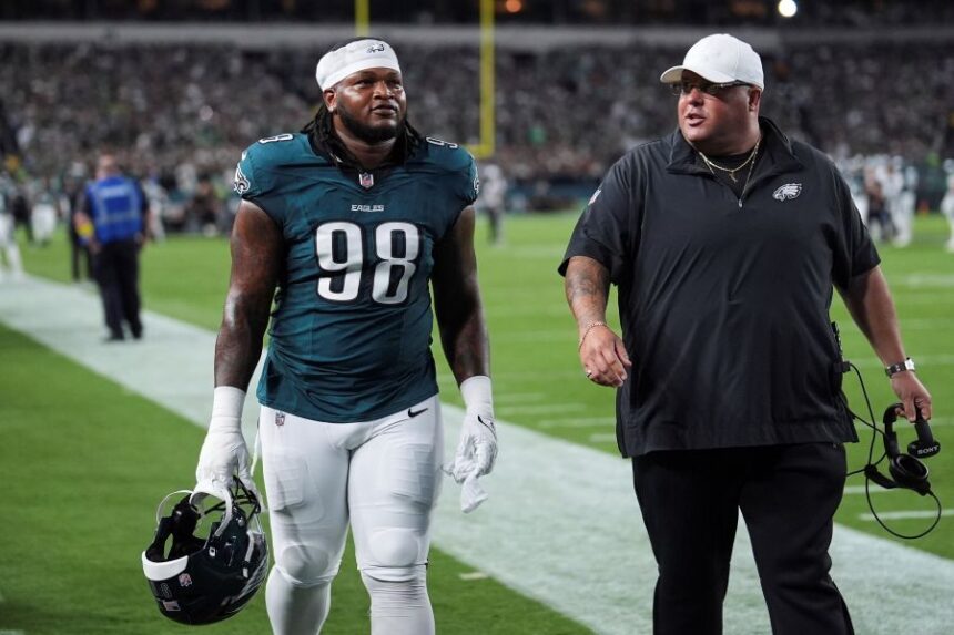 Philadelphia Eagles defensive tackle Jalen Carter (98) walks off the field after being disqualified for unsportsman like conduct before an NFL football game against the Dallas Cowboys Thursday, Sept. 4, 2025, in Philadelphia. (AP Photo/Matt Slocum)