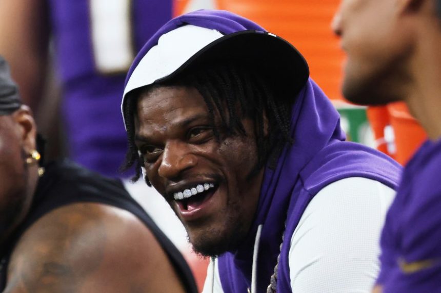 Baltimore Ravens quarterback Lamar Jackson laughs as he talks with teammates on the sideline in the first half of a preseason NFL football game against the Dallas Cowboys Saturday, Aug. 16, 2025, in Arlington, Texas. (AP Photo/Gareth Patterson)