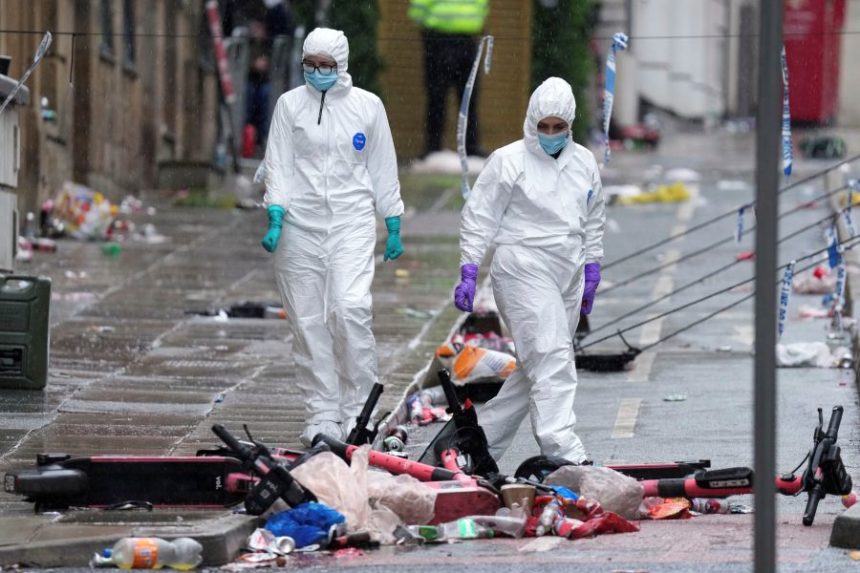 FILE - Forensic officers examine the site where a 53-year-old British man plowed a minivan into a crowd of Liverpool soccer fans who were celebrating the city's Premier League championship Monday, injuring more than 45 people in Liverpool, England, Tuesday, May 27, 2025. (AP Photo/Jon Super, File)