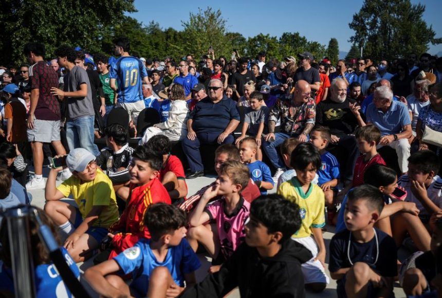 People wait to view the FIFA World Cup winner's trophy at the Italian Cultural Center in Vancouver, British Columbia, Tuesday, Aug. 26, 2025. (Darryl Dyck/The Canadian Press via AP)