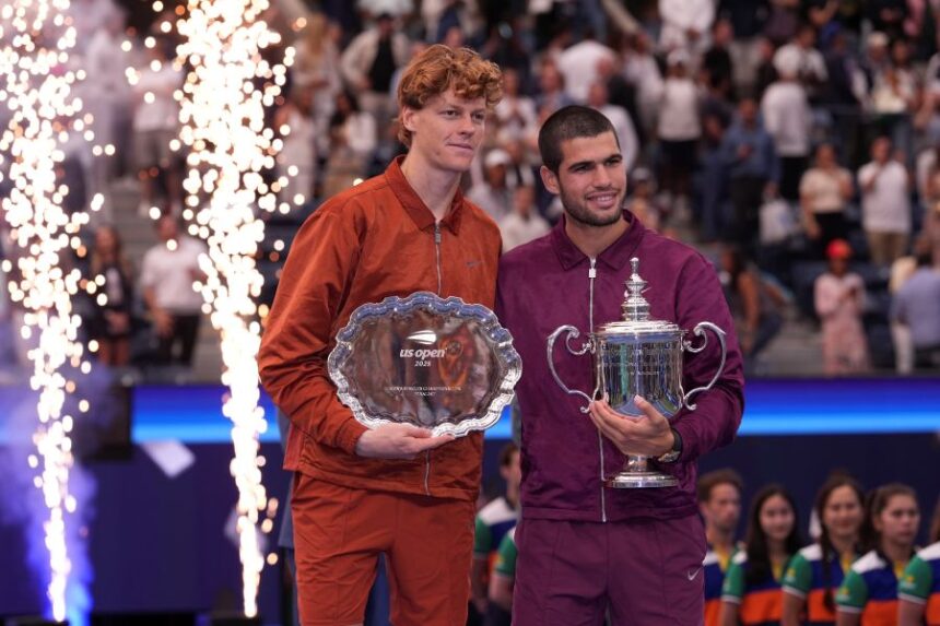 Jannik Sinner, of Italy, left, and Carlos Alcaraz, of Spain, right, hold their trophies after Alcaraz defeated Sinner to win the men's singles final of the U.S. Open tennis championships, Sunday, Sept. 7, 2025, in New York. (AP Photo/Frank Franklin II)