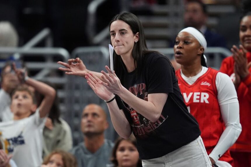 Indiana Fever's Caitlin Clark cheers during the first half of a WNBA basketball game against the Minnesota Lynx, Friday, Aug. 22, 2025, in Indianapolis. (AP Photo/Darron Cummings)