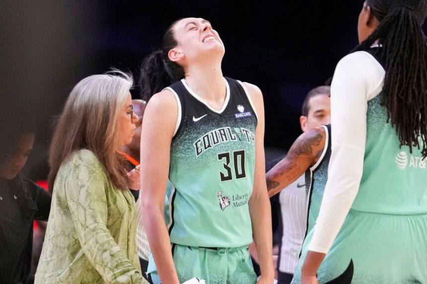 New York Liberty forward Breanna Stewart (30) grimaces after getting fouled by the Phoenix Mercury during the second half of Game 1 during the first round of the WNBA basketball playoffs Sunday, Sept. 14, 2025, in Phoenix. (AP Photo/Darryl Webb)