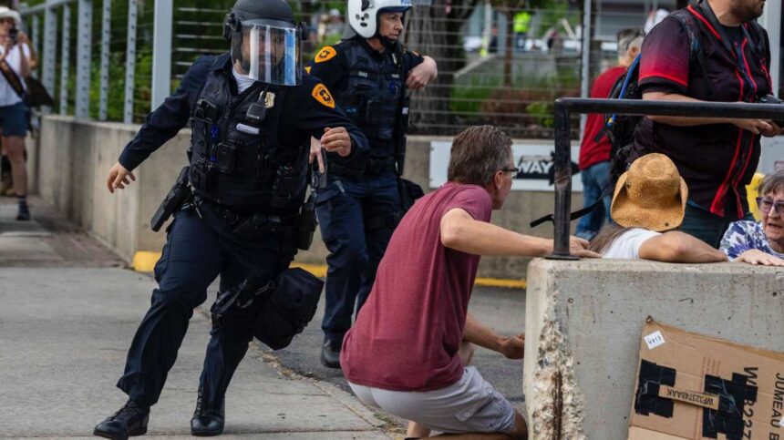 Police rush to respond to a shooting during a “No Kings” protest and march in Salt Lake City on June 14. The widow of a man shot and killed during the protest is calling on Salt Lake City to hold accountable those responsible for her husband's death. | Brice Tucker, Deseret News