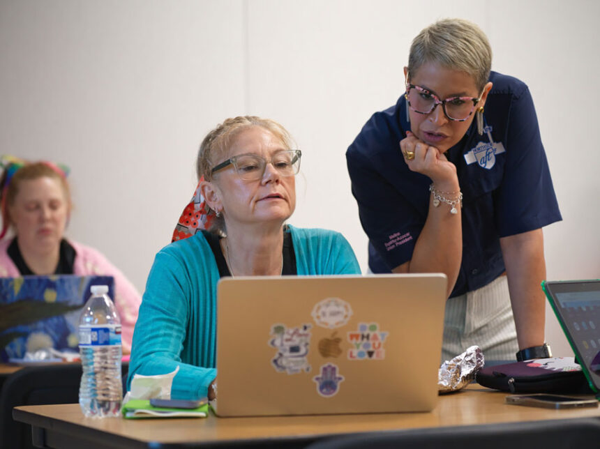 Northside American Federation of Teachers President Melina Espiritu-Azocar, right, speaks with middle school teacher Celeste Simone during a Microsoft AI skilling event, Saturday, Sept. 27, 2025, in San Antonio. | Darren Abate, Associated Press