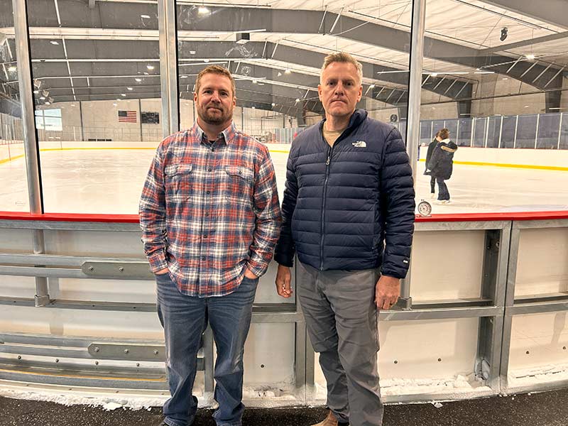 Colin Himmelstein, left, and Jason Rennager pose for a photo inside the new ice rink in Rexburg. | Rett Nelson, EastIdahoNews.com