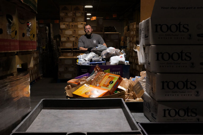 John Jones, operations manager for Idaho Falls Community Food Basket, moving bins of food inside of the food bank's warehouse. | Daniel V. Ramirez, EastIdahoNews.com