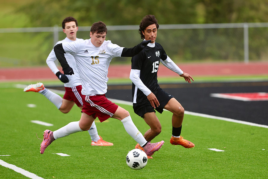 Rigby boys soccer Kian Wilford looks to stop Highland boys soccer Aj Martinez