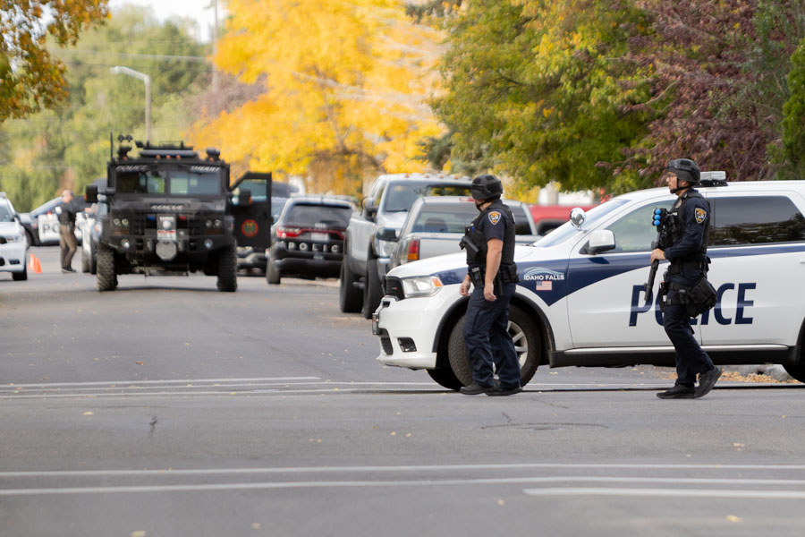 Armed officers with the Idaho Falls Police Department walking towards the home involved with the standoff Monday evening. | Daniel V. Ramirez, EastIdahoNews.com