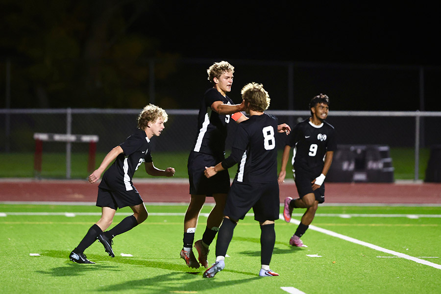 Highland boys soccer Issac Robinson (5) celebrates his goal with teammates