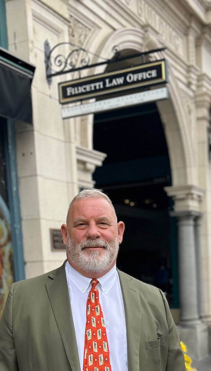Joseph Filicetti stands outside office
