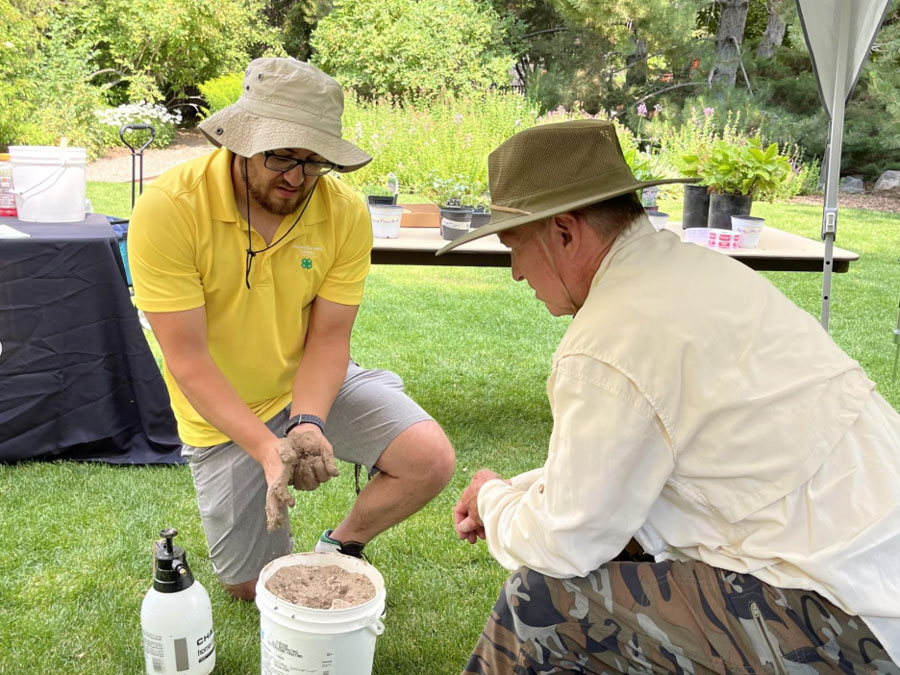 University of Idaho Extension Educator Anthony Simerlink shows a class participant how to determine the texture of a soil sample during a hands-on soils workshop. | Tom Jacobsen, University of Idaho Extension
