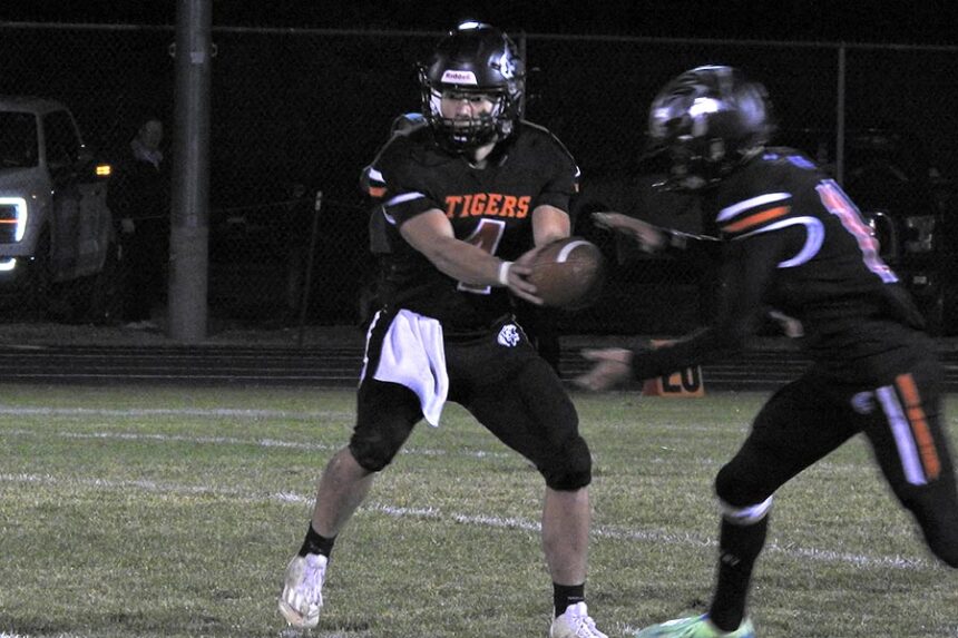 Aberdeen football quarterback Lupe Ortiz (4) runs the read option during the second half of the Tigers' loss to West Side