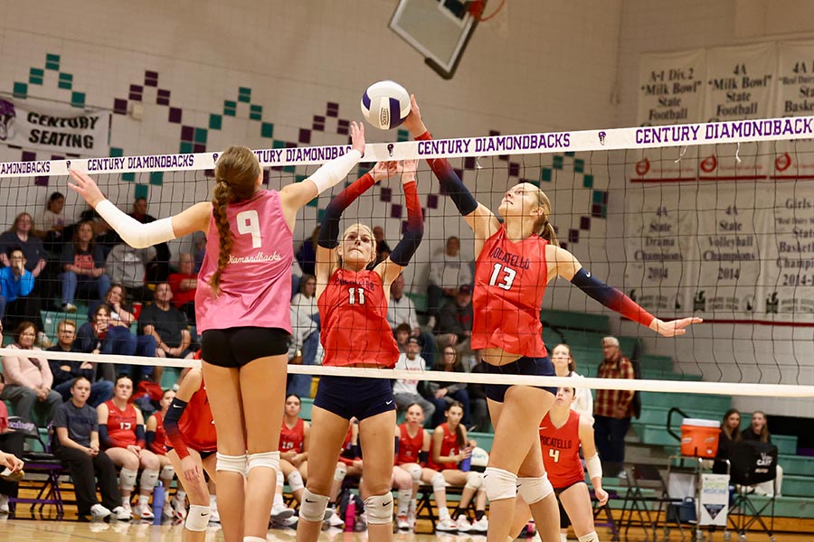 Pocatello volleyball century volleyball Abby Lusk (13) attacks the block of Paige Allen (9)