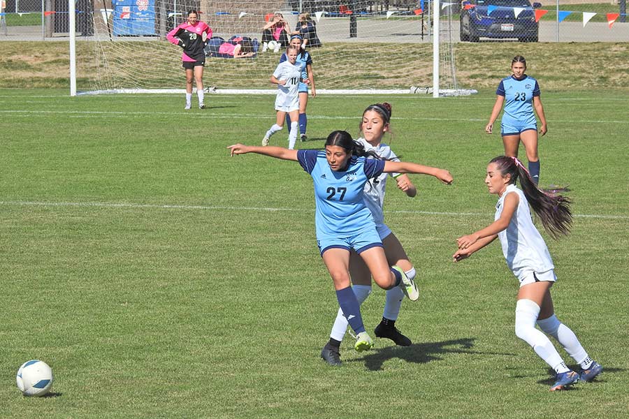 Skyline girls soccer Arianna Zuniga (27) threads the needle