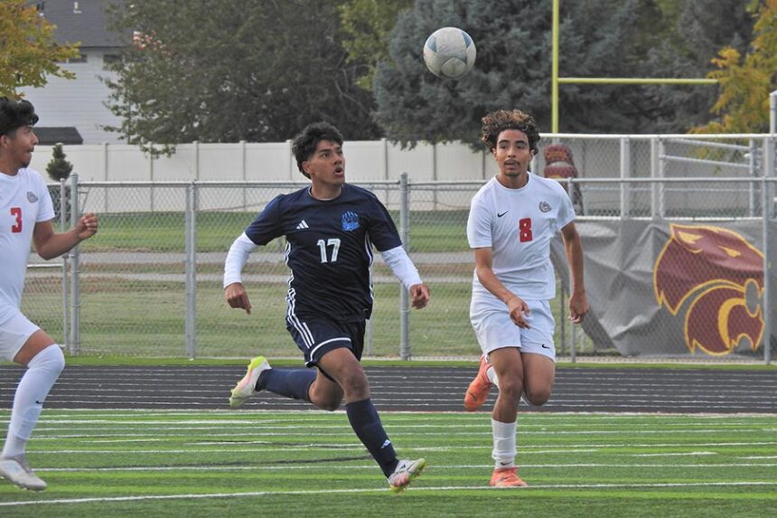Skyline Dennys Mendez races multiple Nampa defenders for possession
