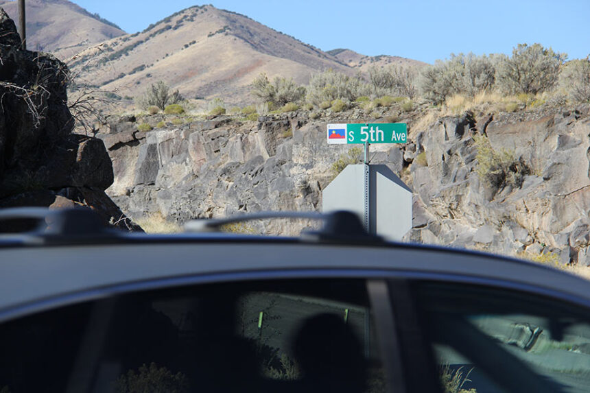 A car whizzes down South 5th Avenue.