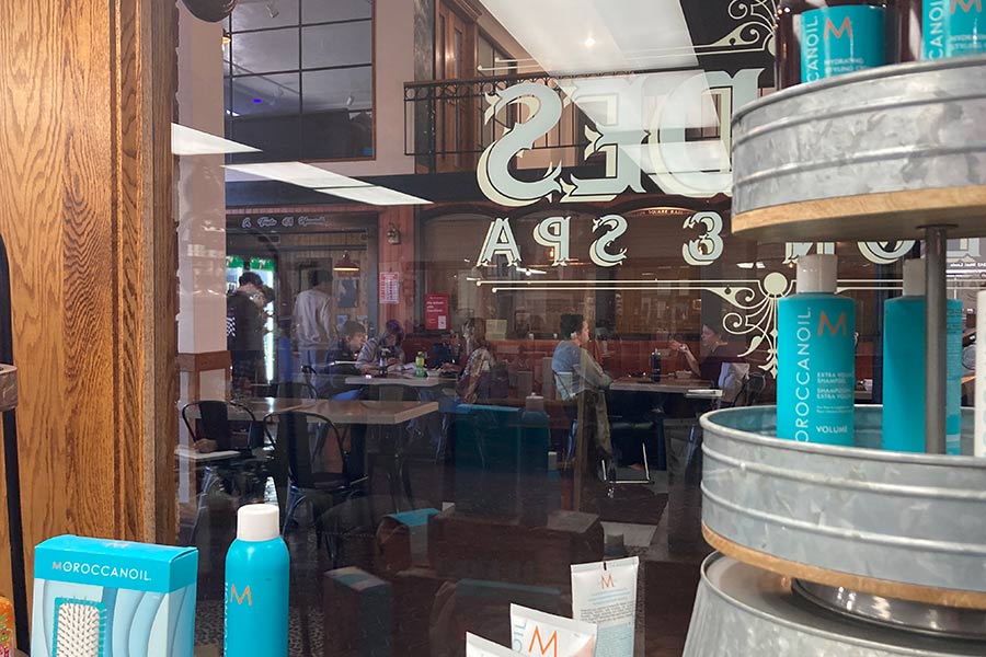 The view of the dining area and Taste of Hawaii from inside Blades Salon & Spa.