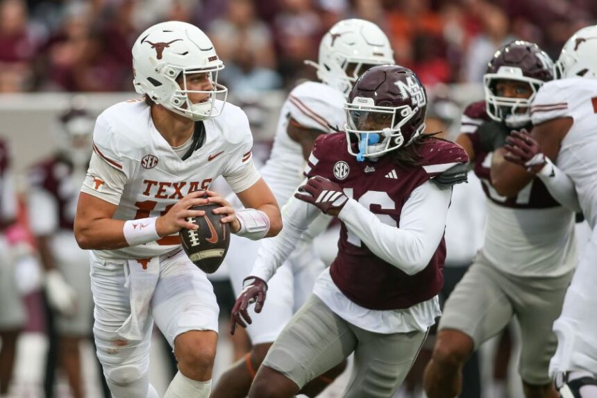 Texas quarterback Arch Manning, left, scrambles out of the pocket against Mississippi State linebacker Derion Gullette, front right, during the first half of an NCAA college football game in Starkville, Miss., Saturday, Oct. 25, 2025. (AP Photo/James Pugh)