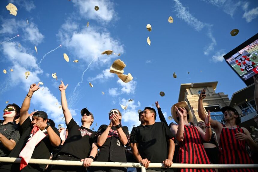 Texas Tech students throw tortillas before the NCAA college football game against Kansas, Saturday, Oct. 11, 2025, in Lubbock, Texas. (AP Photo/Annie Rice)