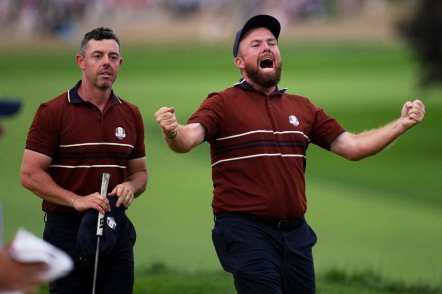 Europe's Shane Lowry and Rory McIlroy react after their match win on the 18th hole at Bethpage Black golf course during the Ryder Cup golf tournament, Saturday, Sept. 27, 2025, in Farmingdale, N.Y. (AP Photo/Matt Slocum)