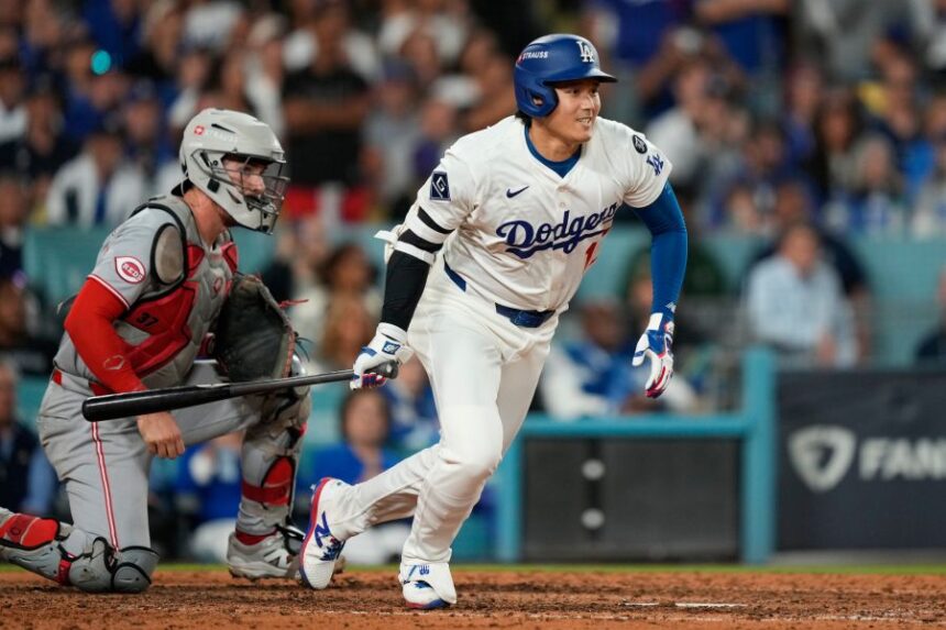Los Angeles Dodgers' Shohei Ohtani follows through on an RBI single during the sixth inning in Game 2 of the National League Wild Card baseball playoff series against the Cincinnati Reds, Wednesday, Oct. 1, 2025, in Los Angeles. (AP Photo/Mark J. Terrill)