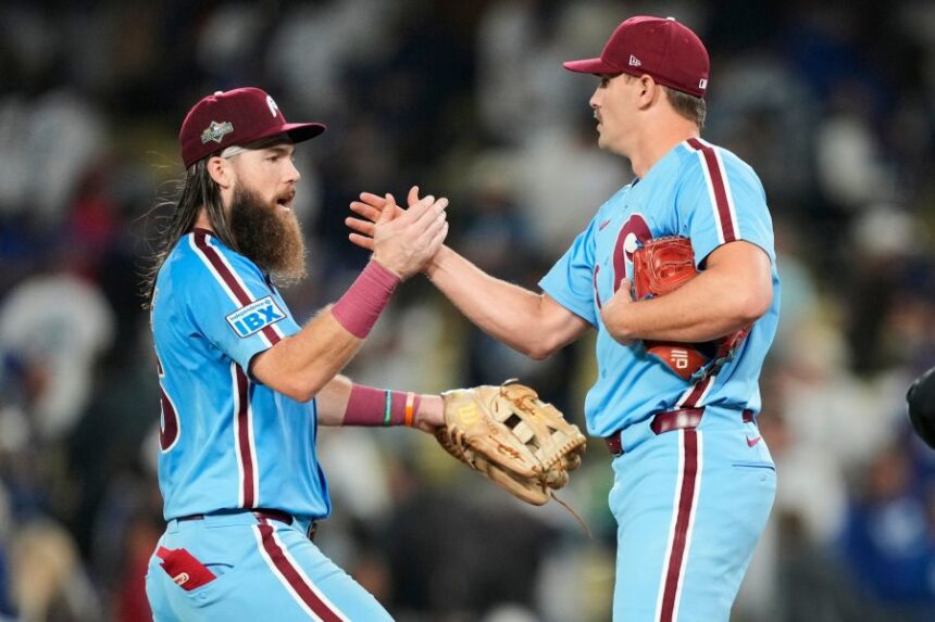 Philadelphia Phillies pitcher Tanner Banks shakes hands with center fielder Brandon Marsh after a win over the Los Angeles Dodgers in Game 3 of baseball's National League Division Series Wednesday, Oct. 8, 2025, in Los Angeles. (AP Photo/Mark J. Terrill)