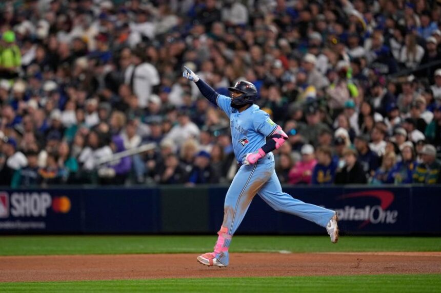 Toronto Blue Jays' Vladimir Guerrero Jr. rounds the bases after hitting a solo home run against the Seattle Mariners during the fifth inning in Game 3 of baseball's American League Championship Series, Wednesday, Oct. 15, 2025, in Seattle. (AP Photo/David J. Phillip)