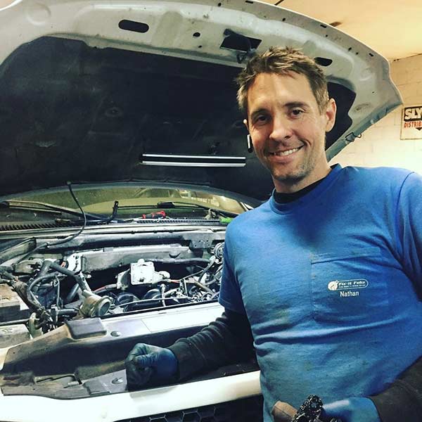 Old photo of Nathan Hansen working on a vehicle in his mechanic shop | Courtesy Nathan Hansen