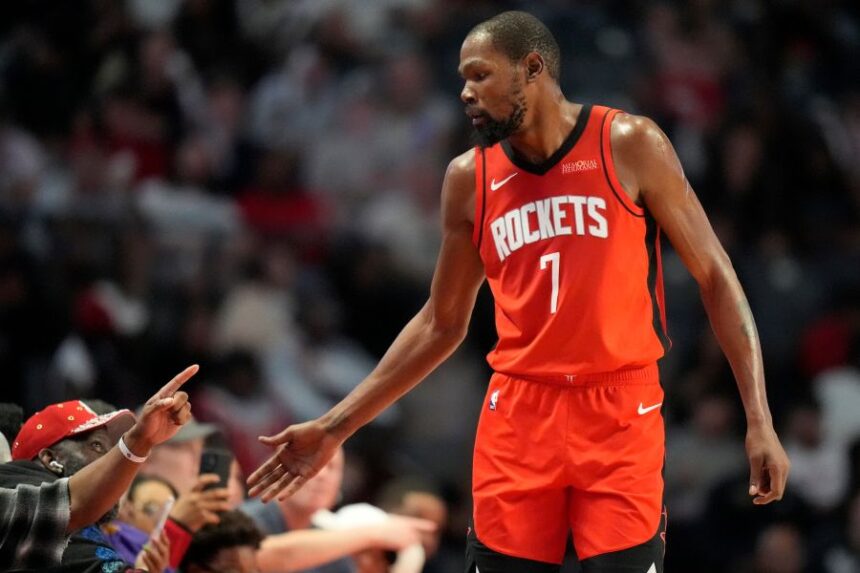 Houston Rockets forward Kevin Durant (7) greets fans during the second half of an NBA preseason basketball game against the New Orleans Pelicans, Tuesday, Oct. 14, 2025, in Birmingham, Ala. (AP Photo/Mike Stewart)