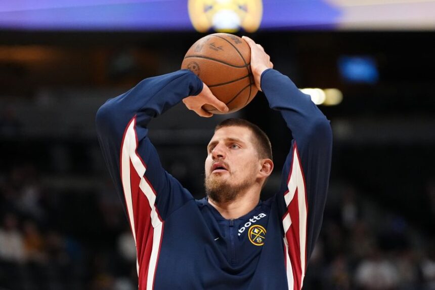 Denver Nuggets center Nikola Jokić warms up before a preseason NBA basketball game against the Chicago Bulls, Tuesday, Oct. 14, 2025, in Denver. (AP Photo/Jack Dempsey)