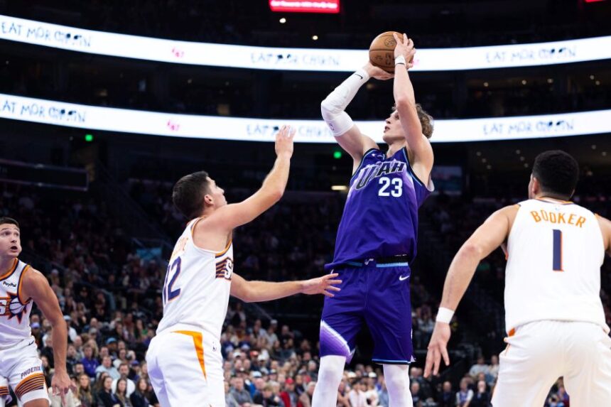 Utah Jazz forward Lauri Markkanen (23) shoots over Phoenix Suns guard Collin Gillespie (12) during the second half of an NBA basketball game, Monday, Oct. 27, 2025, in Salt Lake City. (AP Photo/Anna Fuder)