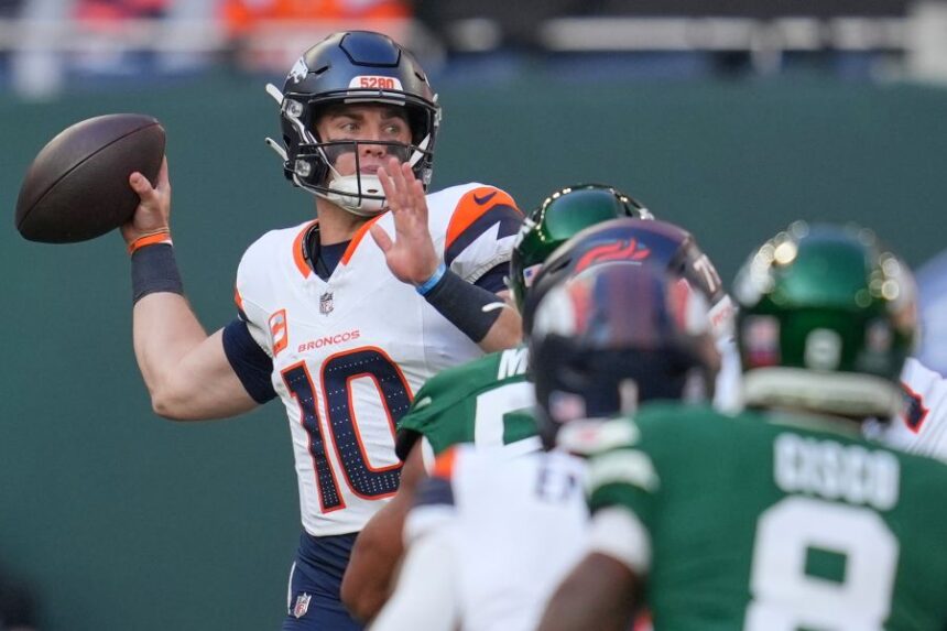 Denver Broncos quarterback Bo Nix passes the ball in the first half of an NFL football game between the Denver Broncos and the New York Jets, Sunday, Oct. 12, 2025, in London. (AP Photo/Kin Cheung)