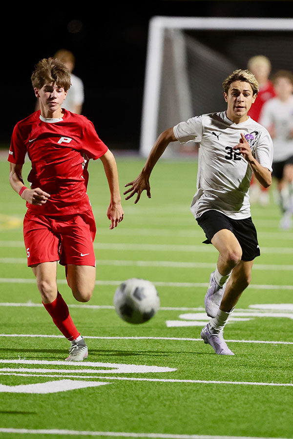 Pocatello's Jaxon Miller races Century's Lukas Hair to the ball