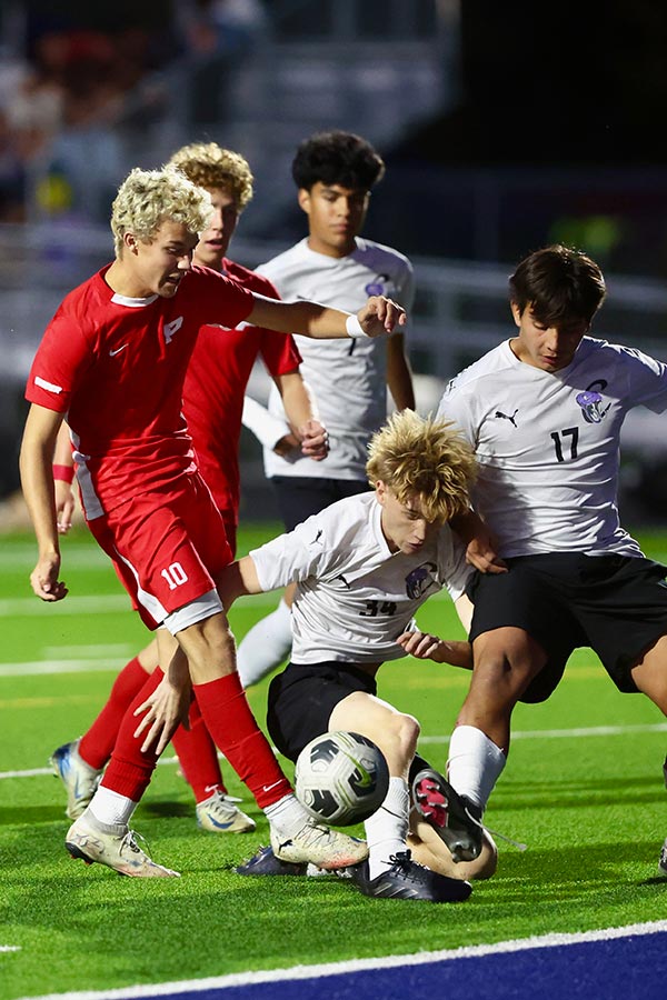 Pocatello boys soccer Zen Griggs scores past several Century defenders